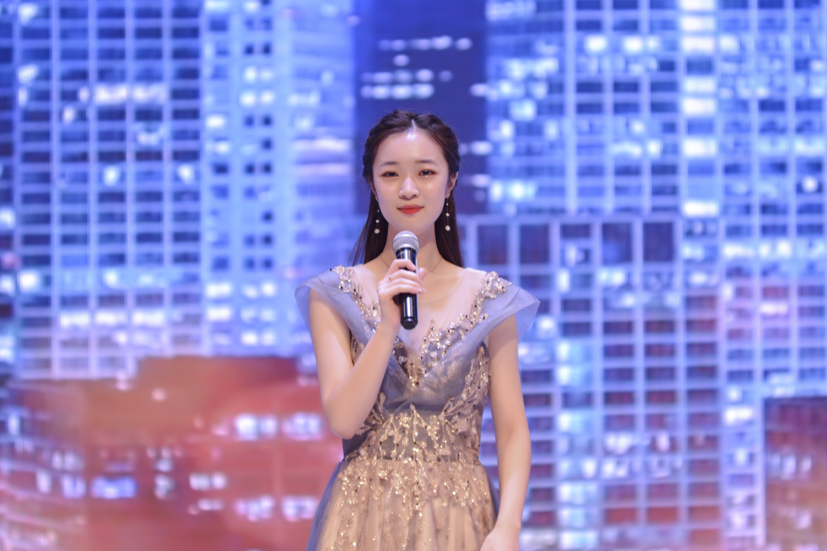 Mina performing a solo on a large concert stage